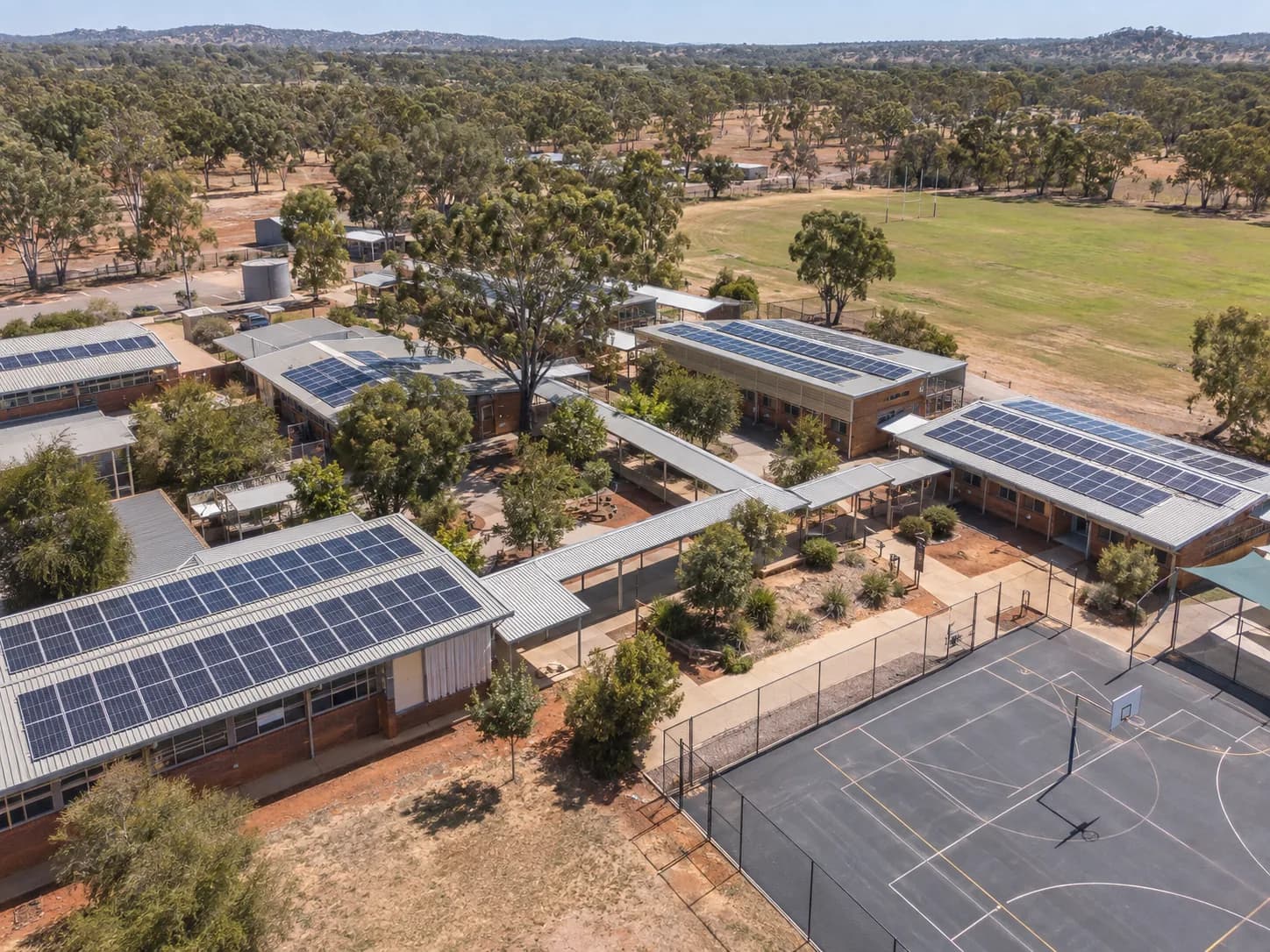 A school campus with solar panels across several classroom blocks